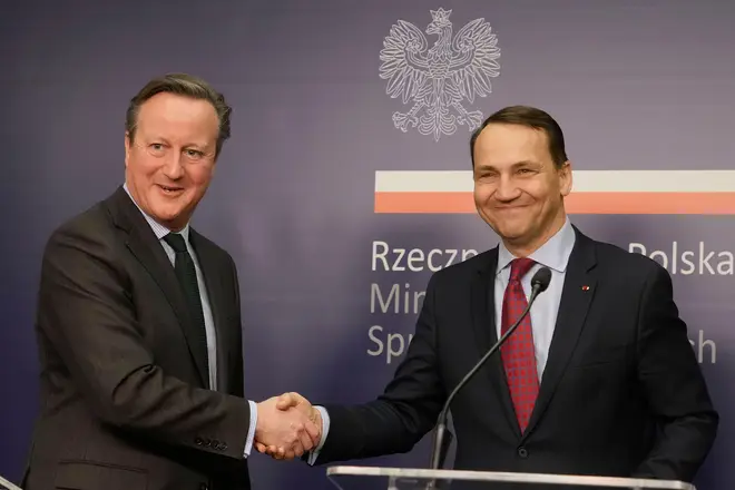 David Cameron (l), and his Polish host, Foreign Minister Radek Sikorski, (r) , tell reporters they are appealing to the U.S. Congress to approve aid package for Ukraine,