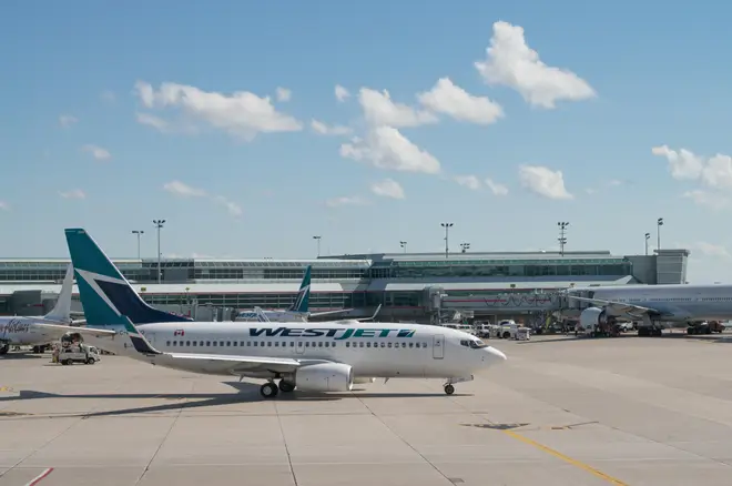 West Jet plane on the apron at Toronto Pearson International airport, Ontario, Canada