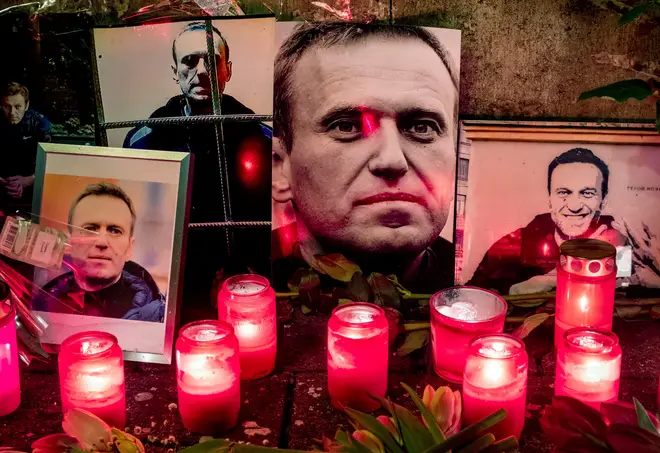 Candles and photos of Russian opposition leader Alexei Navalny are placed near the Russian consulate in Frankfurt, Germany, Saturday