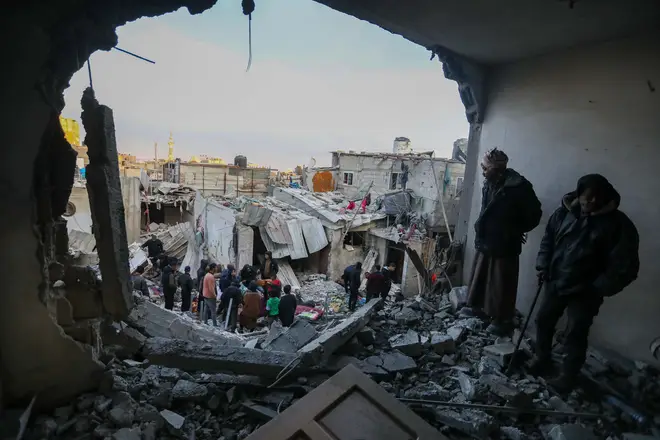 People inspect the damage to their homes following Israeli air strikes  on February 12, 2024 in Rafah, Gaza.