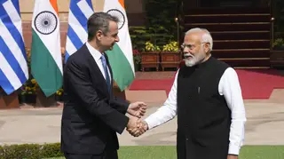 Greece’s Prime Minister Kyriakos Mitsotakis, left, talks with his Indian counterpart Narendra Modi as he arrives for a delegation level meeting in New Delhi (Manish Swarup/AP)