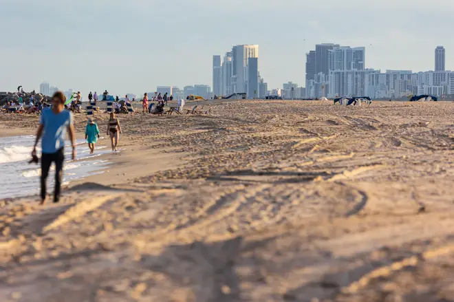 People enjoy the beach in the late afternoon sun, December 23, 2022, in Fort Lauderdale, Florida