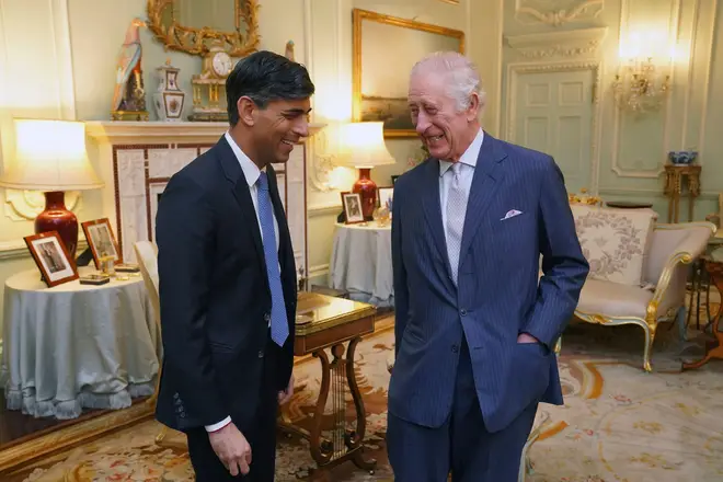 King Charles III and Britain's Prime Minister Rishi Sunak smile during their meeting in Buckingham Palace, Wednesday