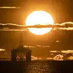 Sun rises behind a redundant oil platform (Jane Barlow/PA)