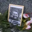 Flowers next to a portrait of Russian opposition leader Alexei Navalny