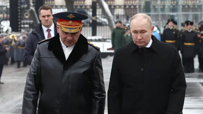 Russian President Vladimir Putin, right, and defence minister Sergei Shoigu take part in a wreath-laying ceremony at the Tomb of the Unknown Soldier in Alexander Garden on Defender of the Fatherland D