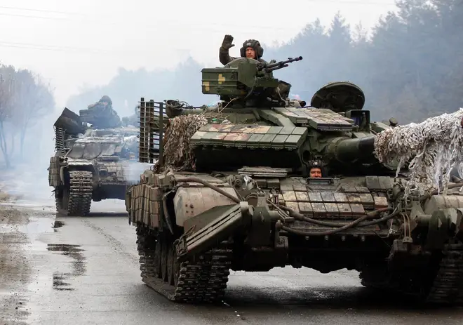 Ukrainian servicemen ride on tanks towards the front line nearly two years ago