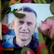 A picture of Alexei Navalny next to flowers in front of the Russian embassy in Berlin