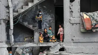 Children are seen in a building destroyed in an Israeli air strike in the southern Gaza Strip city of Rafah, February 22