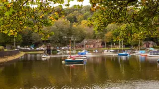 Rudyard Lake reservoir in the Staffordshire Moorlands near Leek seen with sailing boats moored in the Autumn  Autumnal colours in the woodland trees