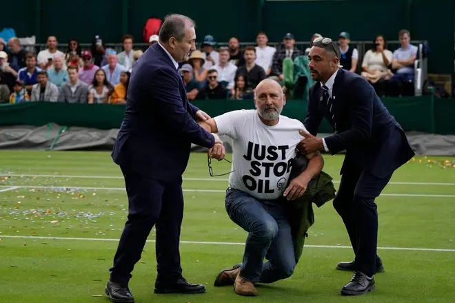 A Just Stop Oil protester is removed from Court 18 on day three of the Wimbledon tennis championships in London, July 5, 2023