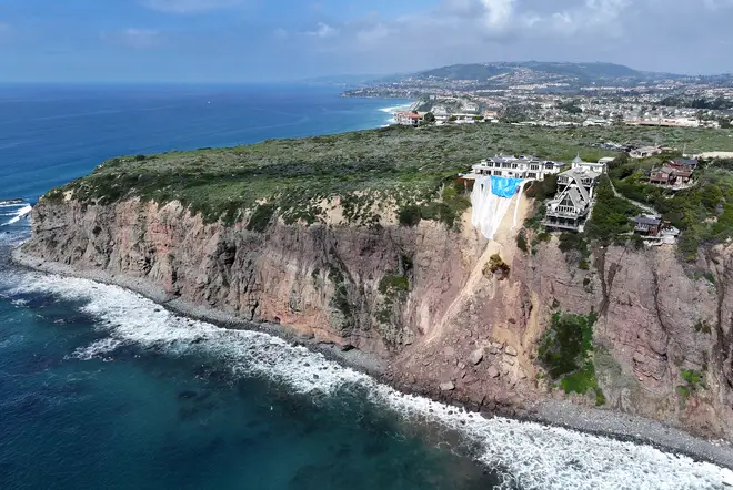 An aerial view of mansions still standing along a cliff in Dana Point
