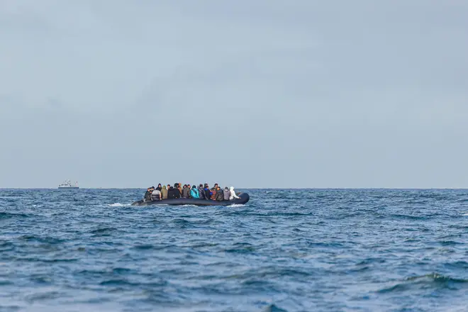 Migrants on a boat crossing the channel between France and UK heading towards the port of Dover