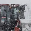 A tractor clears snow