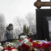 Alexei Navalny's mother puts flowers on his grave