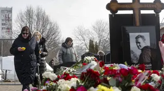 Alexei Navalny's mother puts flowers on his grave