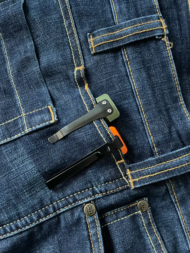 The original Olight Arkfeld (left and the new Pro right) this image features a pair of 5.11 jeans...