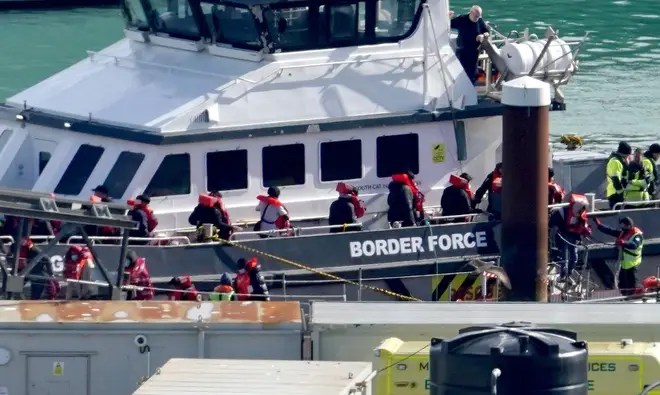 A group of people thought to be migrants are brought in to Dover, Kent, by a Border Force vessel on Monday