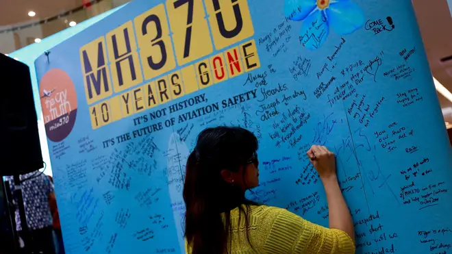 Relatives of passengers on a Malaysia Airlines plane that mysteriously vanished 10 years ago writing a messages at Day of Remembrance For MH370