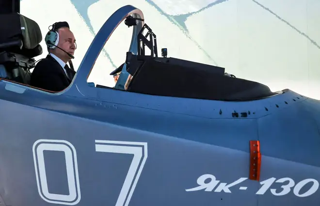 Russian President Vladimir Putin sits in a cockpit of a flight simulator at the Krasnodar Higher Military Aviation School of Pilots named in Krasnodar, Thursday