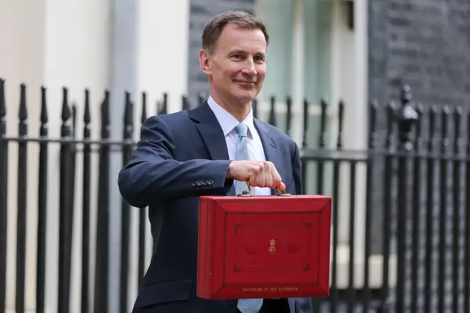 The United Kingdom's (UK) Chancellor of the Exchequer Jeremy Hunt poses for photographs as he leaves 11 Downing Street