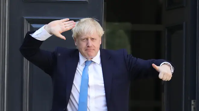 Boris Johnson gives a thumbs-up to photographers