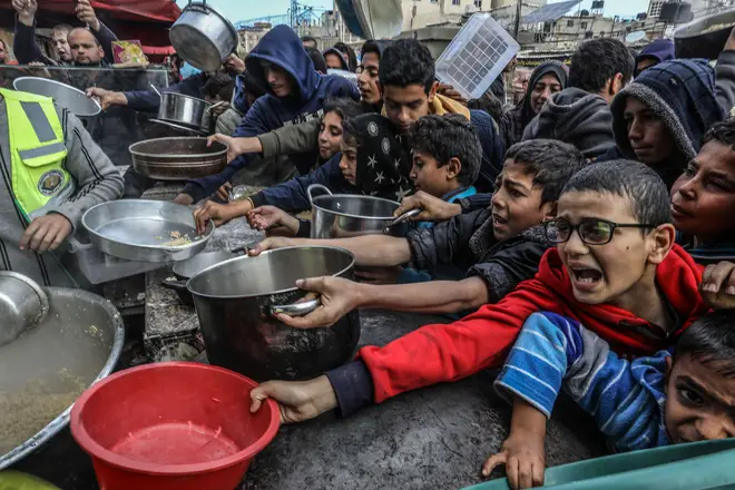Displaced Palestinians wait for food in Rafah, south of the Gaza Strip, January 26, 2024