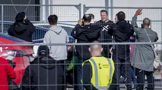 Tesla CEO Elon Musk, fourth from right, arrives at the Tesla Gigafactory for electric cars in Gruenheide near Berlin, Germany (Ebrahim Noroozi/AP)