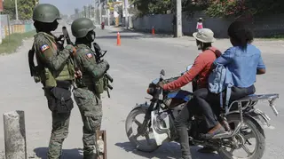 Soldiers patrol the road near the international airport in Port-au-Prince, Haiti