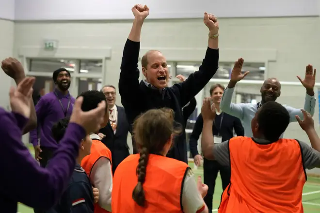Prince William celebrates with young people after he threw a basket during his visit to WEST, the new OnSide Youth Zone in Hammersmith and Fulham in London