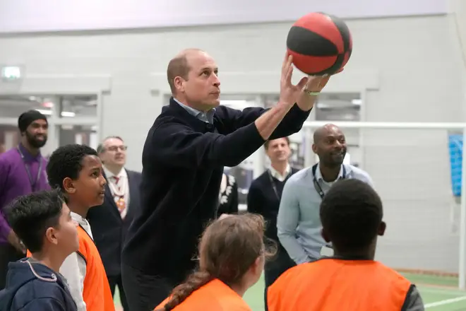 Prince of Wales shoots a basket on a charity visit