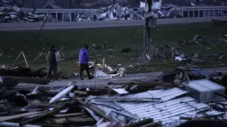 People walk through debris from severe storms in Lakeview, Ohio