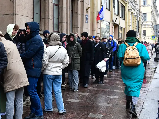 Voters queue outside a polling station during Russia's presidential election in Saint Petersburg on 17 March