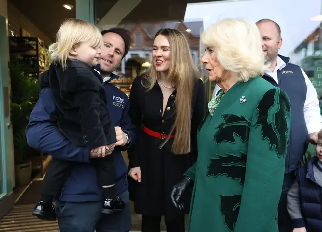 Queen Camilla (centre right) meets the owner of Knotts Bakery, William Corrie, his wife Zoe Salmon and their son Fitz during a visit to Lisburn Road in Belfast to meet shop owners and staff