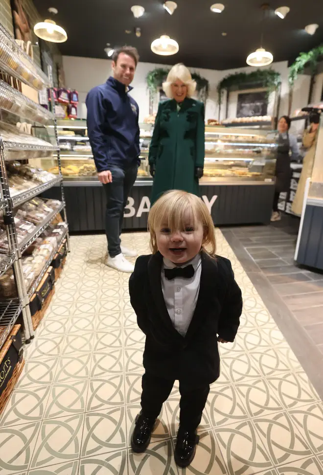 Dressed up in a black and white tuxedo, 23-month-old Fitz Corrie Salmon beamed at the Queen.