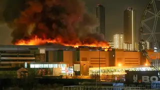 A massive blaze is seen over the Crocus City Hall on the western edge of Moscow, Russia