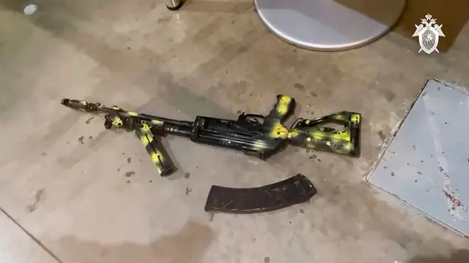 In this photo taken from video released by Investigative Committee of Russia on Saturday, March 23, 2024, a Kalashnikov assault rifle lies on the ground