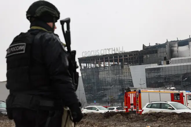 A law enforcement officer patrols the scene of the gun attack at the Crocus City Hall concert hall in Krasnogorsk