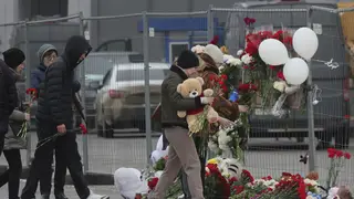 People place flowers at the scene