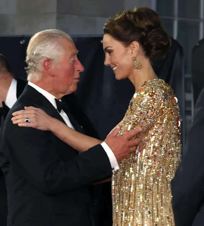 Then Prince Charles speaks with Kate, then the Duchess of Cambridge, as they arrive for the premiere of James Bond 'No Time To Die', September 28, 2021