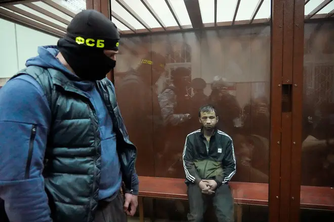 Shamsidin Fariduni, a suspect in the Crocus City Hall shooting on Friday sits in a glass cage in the Basmanny District Court in Moscow