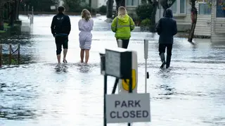 People walk through flooding