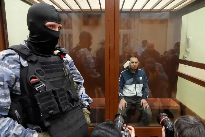 Saidakrami Rachabalizoda, a suspect in the Crocus City Hall shooting on Friday sits in a glass cage in the Basmanny District Court in Moscow