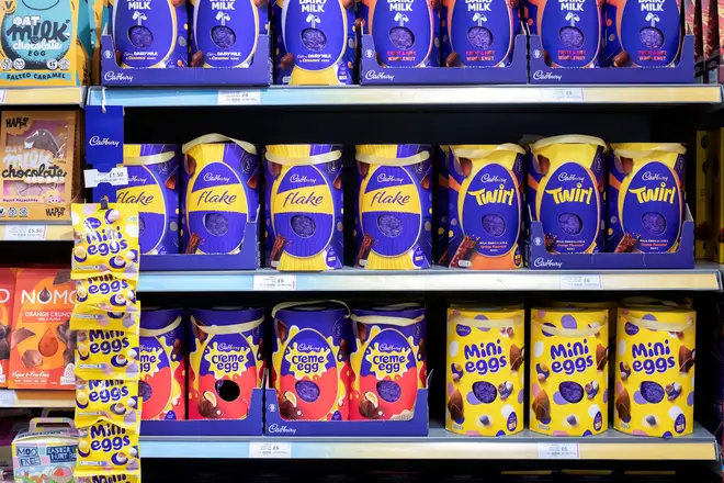 UK supermarket shelves filled with Cadbury Easter Eggs. The assortment includes Cadury Flake, Twirl Creme egg and mini Eggs