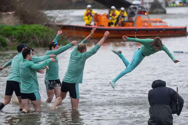 Members of the Cambridge crew throw their cox Jasper Parish into the water as they celebrate the winning of the men s boat race between Oxford University and Cambridge University on the River Thames