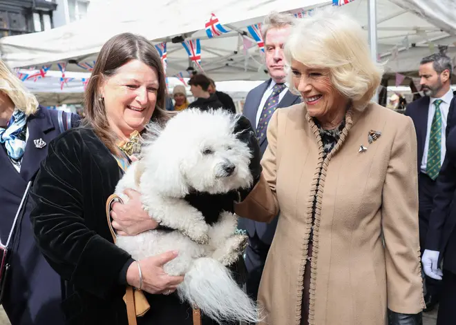 Camilla meets a dignitary and her dog during a visit to the Farmers' Market