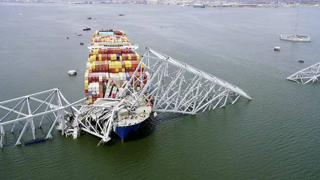 The cargo ship Dali stuck under part of the structure of the Francis Scott Key Bridge after the ship hit the bridge in Baltimore