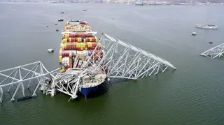 The cargo ship Dali stuck under part of the structure of the Francis Scott Key Bridge after the ship hit the bridge in Baltimore