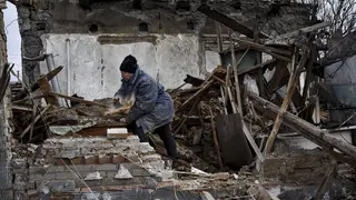 Resident clears rubble from home