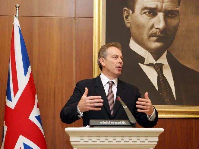 Tony Blair stands in front of the Union Jack